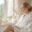 a bride to be in a luxurious spa setting preparing for a skincare treatment before her wedding day surrounded by candles and aesthetic products