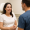 Smiling woman consulting with a doctor in a clinic.