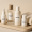 Skincare set with labeled bottles of serum, toner, lotion, and cream on a tray.