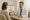 a provider explains the laser lipo renuvion process to a patient using a visual cross-section of fat layers on a screen.