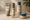 a minimalist skincare lineup including toner, serum, and face cream displayed on a counter.