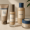 a minimalist skincare lineup including toner, serum, and face cream displayed on a counter.
