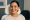 a woman receives a cosmetic injection between her eyebrows to reduce fine lines.