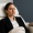 Businesswoman relaxing with eyes closed in a medical spa chair, covered with a blanket.