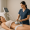 A technician performs a non-surgical body contouring treatment using a handheld device on a patient's abdomen.